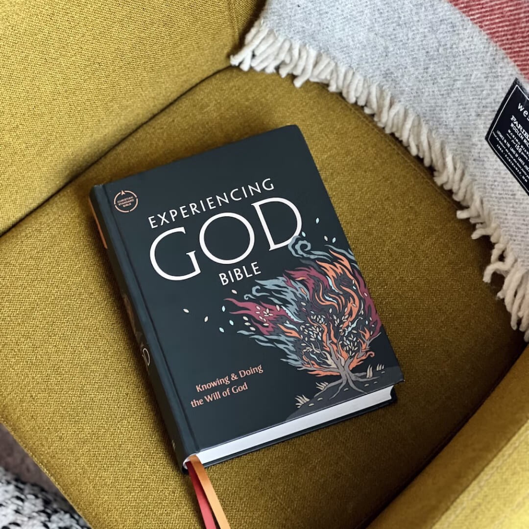 Christian book about experiencing God placed on a couch with a blanket.