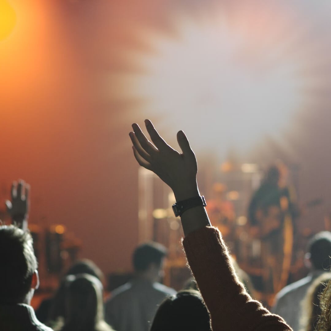 Church congregation raising hands in worship during a church service.