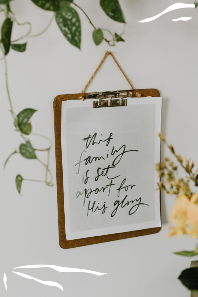 Decorative sign reading “This family is set apart for His glory” representing Christian family values.