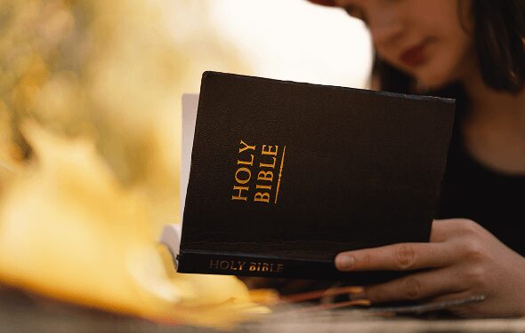 christian-teen-girl-holds-bible-in-her-hands-read